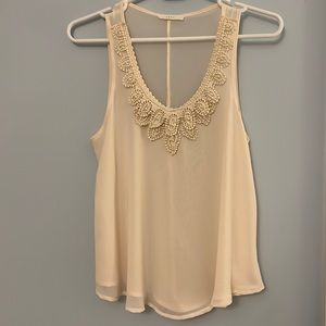 Cream tank top with faux pearl-beaded neckline from Lush